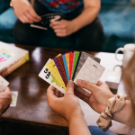 A Woman Holding Colorful Cards