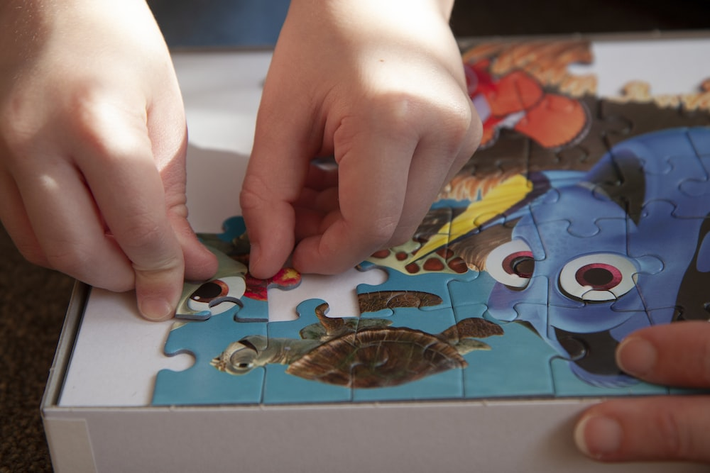 a child completing a “Finding Nemo” jigsaw puzzle