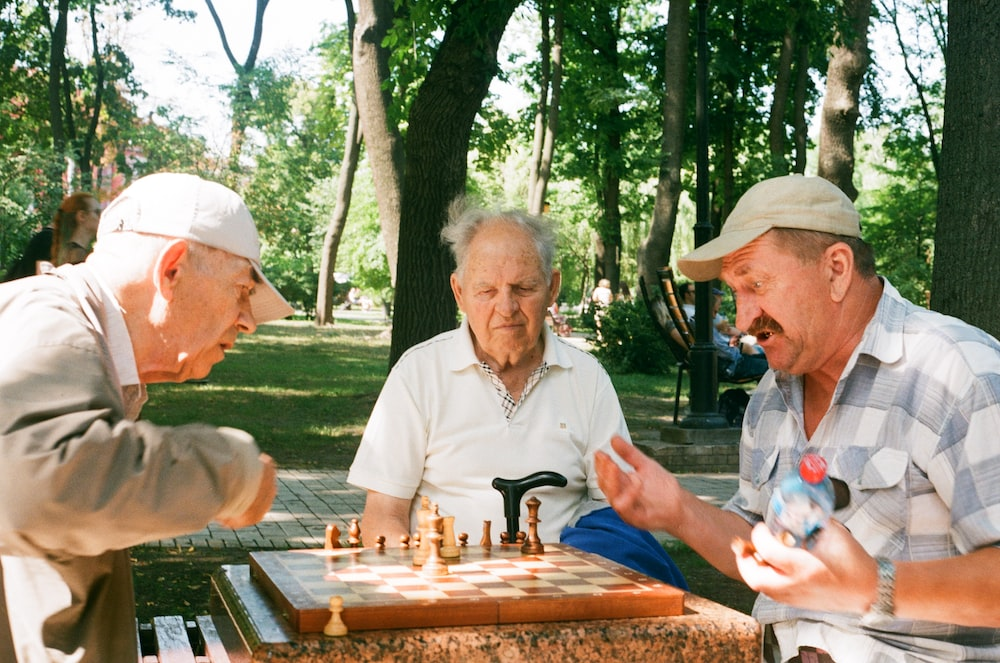 men playing chess at a table