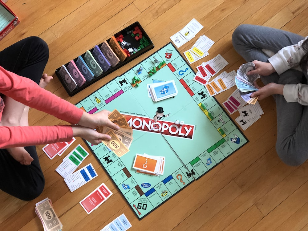 children playing monopoly on the floor