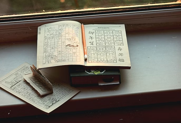 sudoku booklet in front of a window